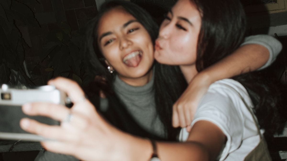 Girls posing for a film camera